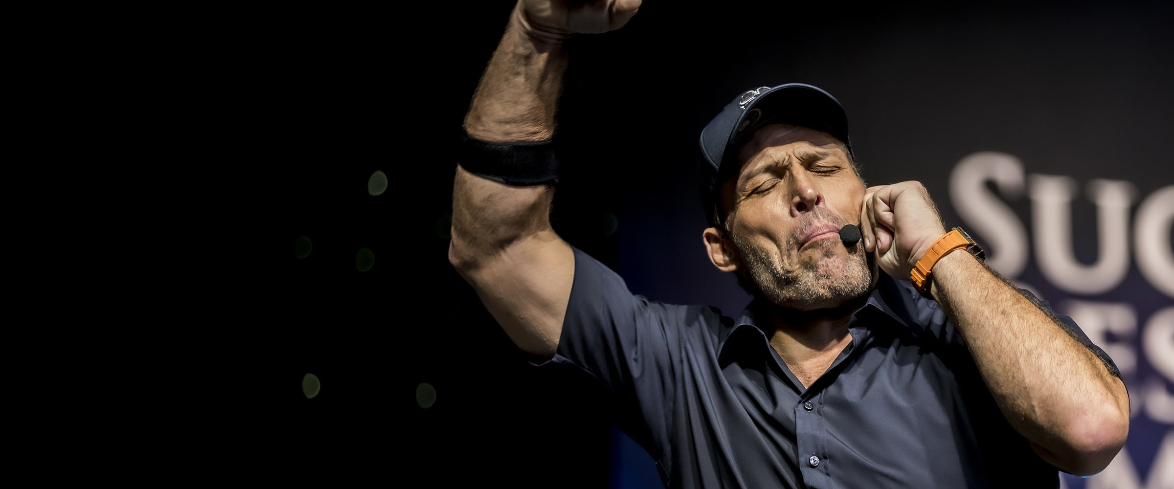 Tony Robbins speaking on stage at a live event captured by HDPerfect
